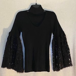 Pre-loved high neck sweater with cut out lapel and lace bell sleeves.